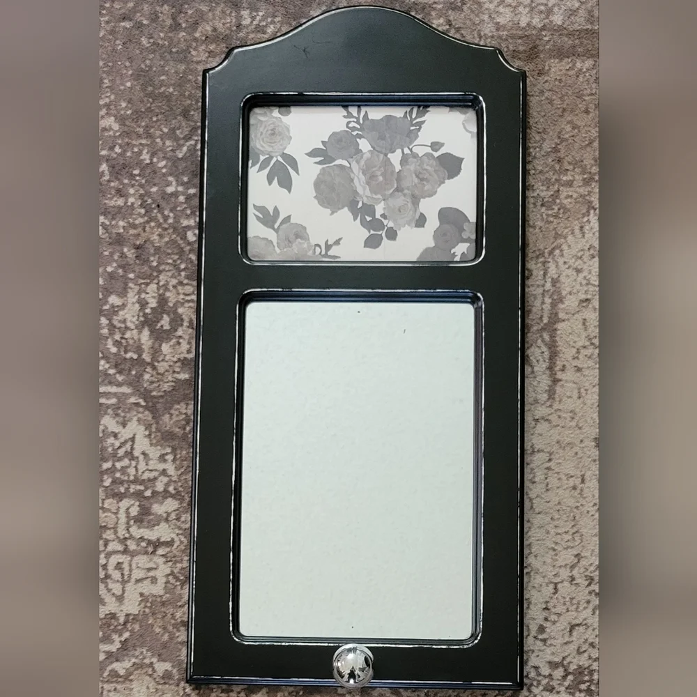 Elegant Black Wall Mirror with Floral Accent